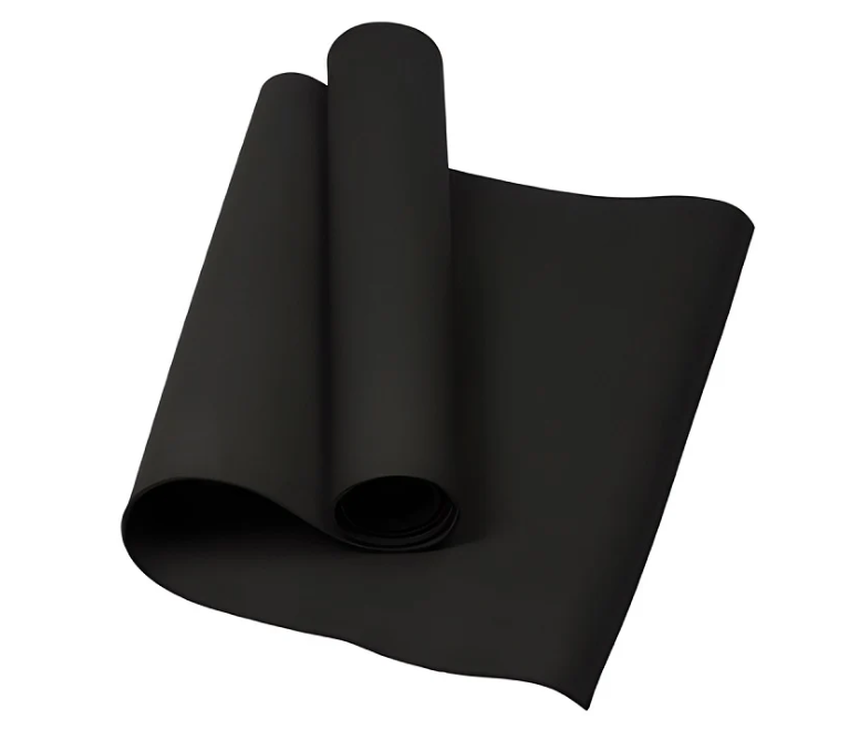 Black anti-slip yoga mat rolled and partially unrolled for home workout.