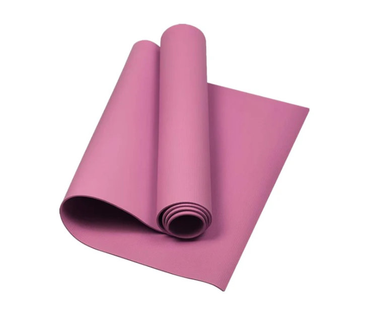 Black anti-slip yoga mat rolled and partially unrolled for home workout.